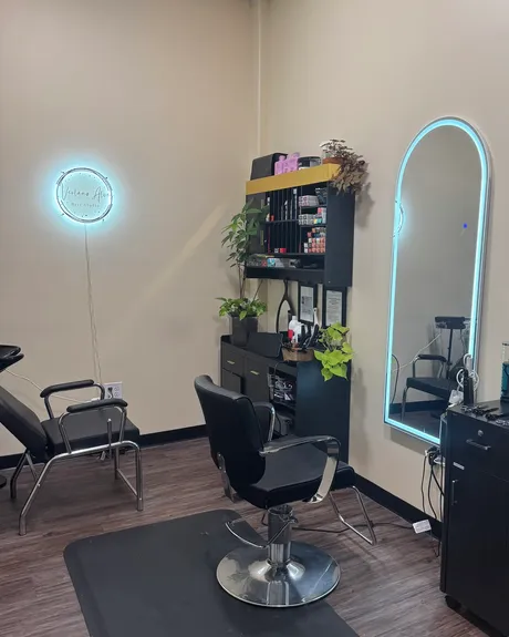 The private studio: one styling chair, a wash basin and a lit mirror