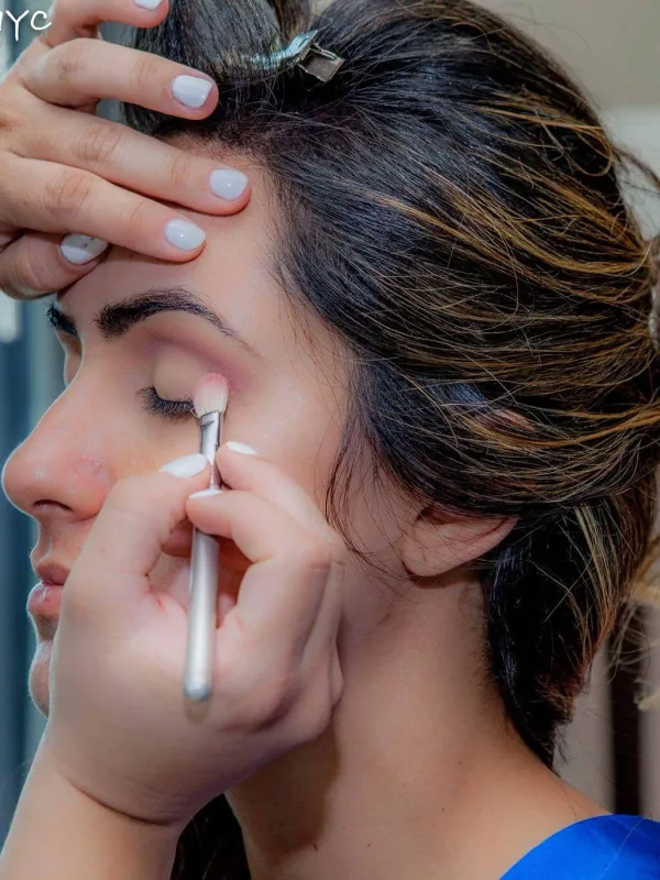 Bridal makeup being finished with the hair pinned up
