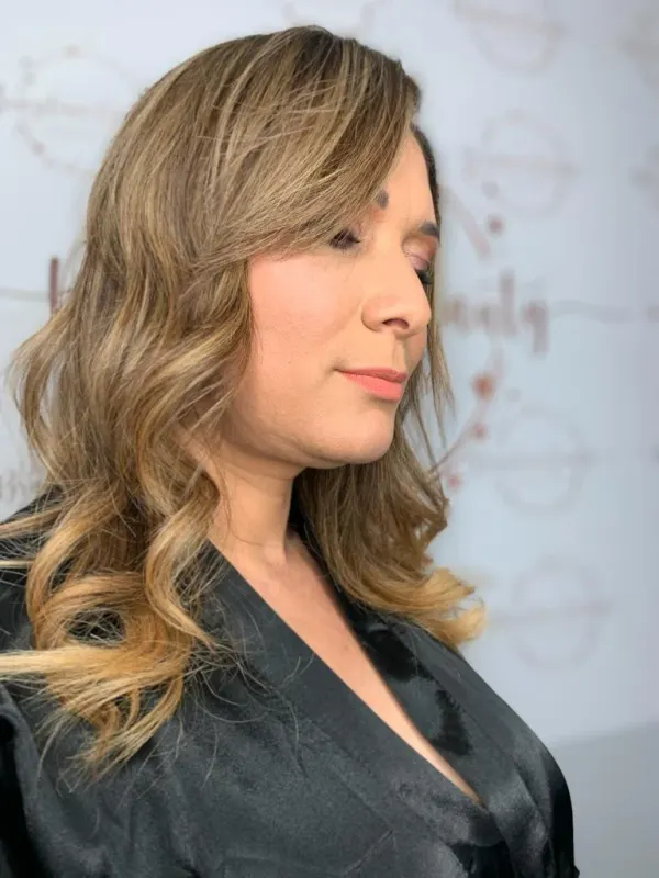 Bronde balayage on a dark base, worn in a soft side wave