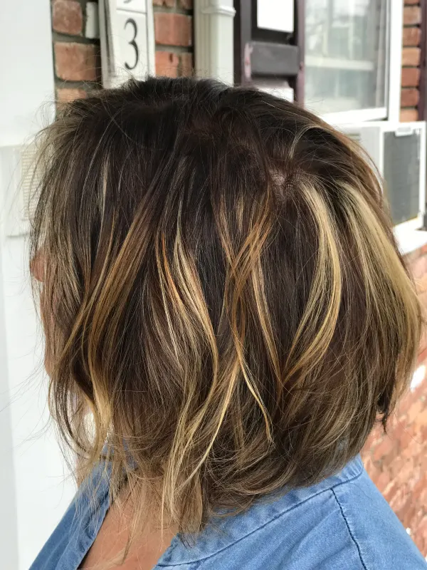 Textured lob cut to fall forward, with balayage broken through the ends