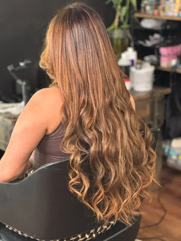 Caramel extensions taken past the waist, color matched to the natural hair