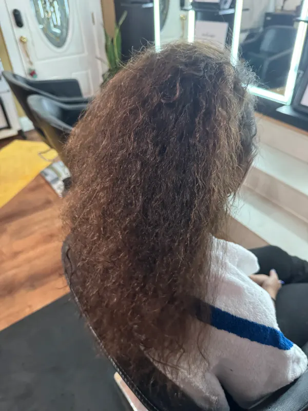 Before the smoothing, from the side: curl pattern packed tight at the root